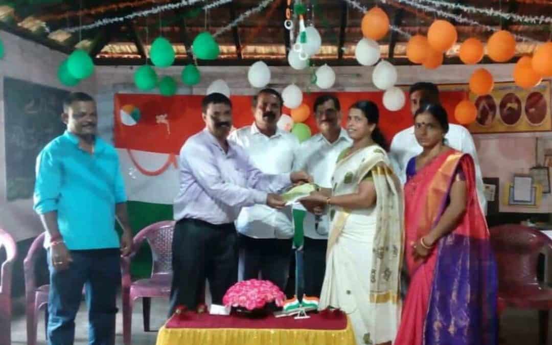 Handing over of cheque towards a teacher’s salary to DK ZP HP School Bengre